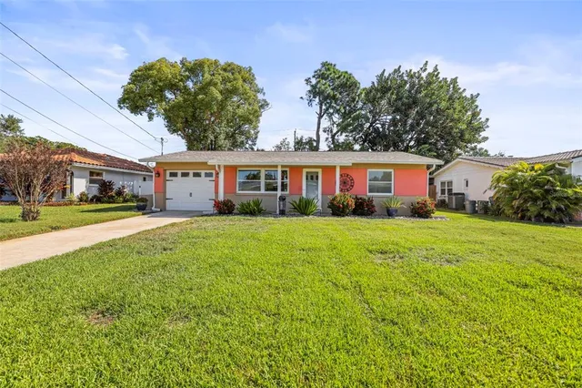 a front view of a house with yard and green space