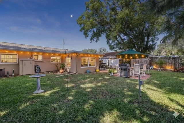a backyard of a house with table and chairs