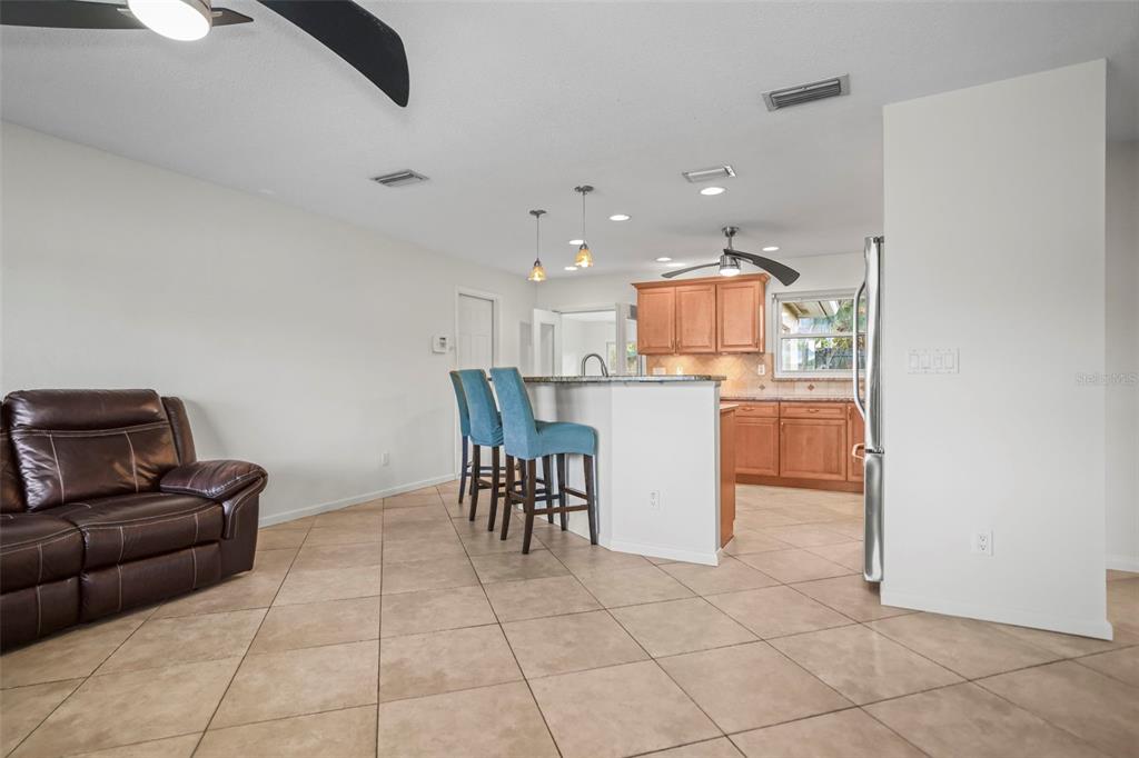 1215 Lazy Lake Road East Dunedin, FL 34698 - Photo 10 of 46 a living room with furniture and kitchen view