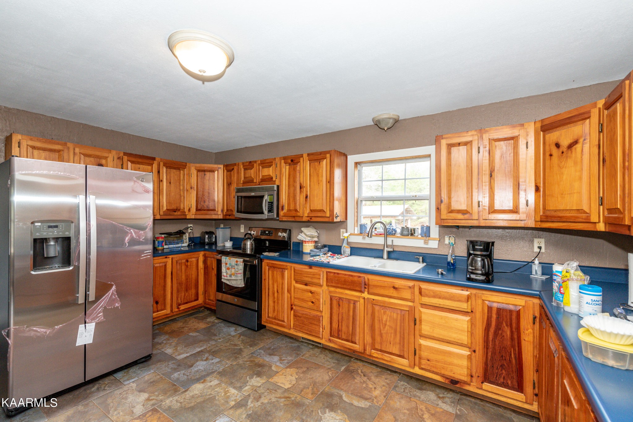 1620 Reliance Road Tellico Plains, TN 37385 - Photo 8 of 59 a kitchen with stainless steel appliances granite countertop a stove top oven a sink dishwasher a refrigerator and cabinets with wooden floor