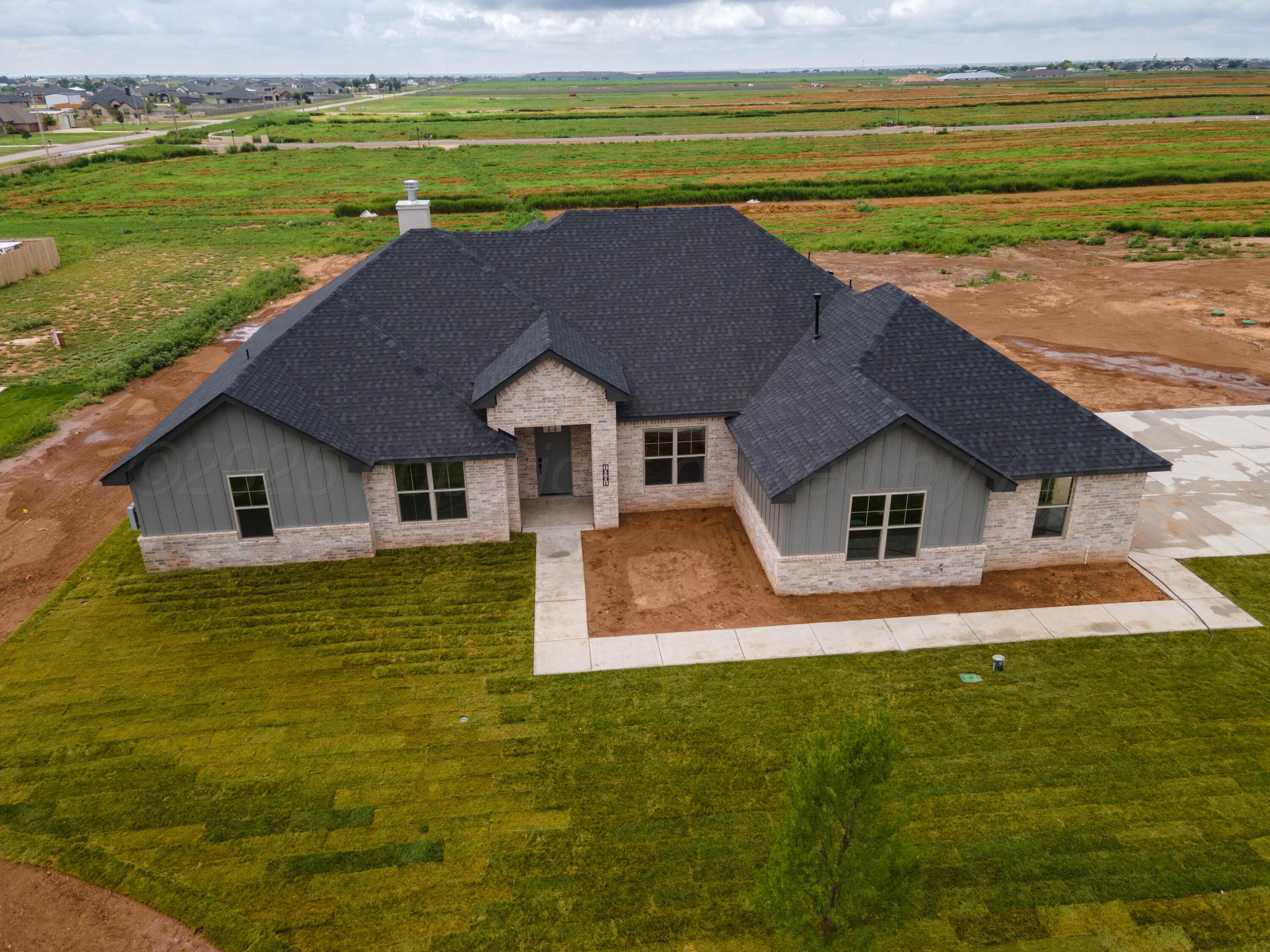 10201 Prickly Pear Road Amarillo, TX 79119 - Photo 54 of 56 a front view of a house with a yard