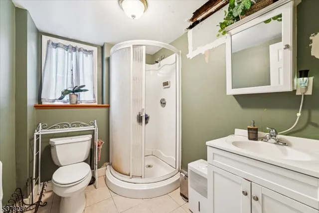 a bathroom with a toilet sink shower and mirror