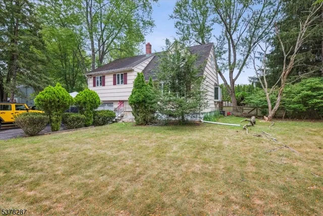 a view of a house with backyard and tree s