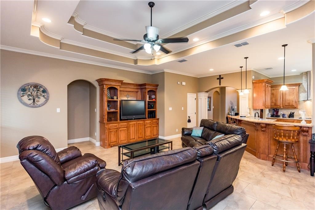 1306 Keenland Road Corpus Christi, TX 78418 - Photo 7 of 26 a living room with furniture a flat screen tv and kitchen view