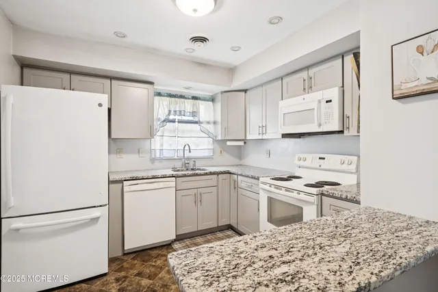 a kitchen with a sink stove and refrigerator
