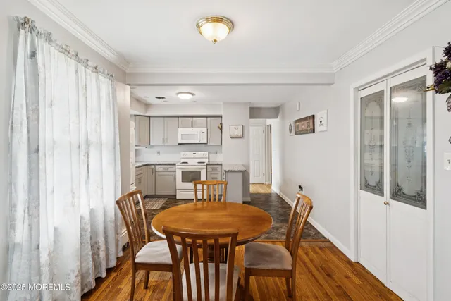 a view of a dining room with furniture and window
