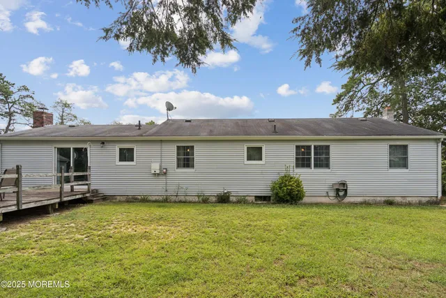 a view of a house with a yard patio and fire pit