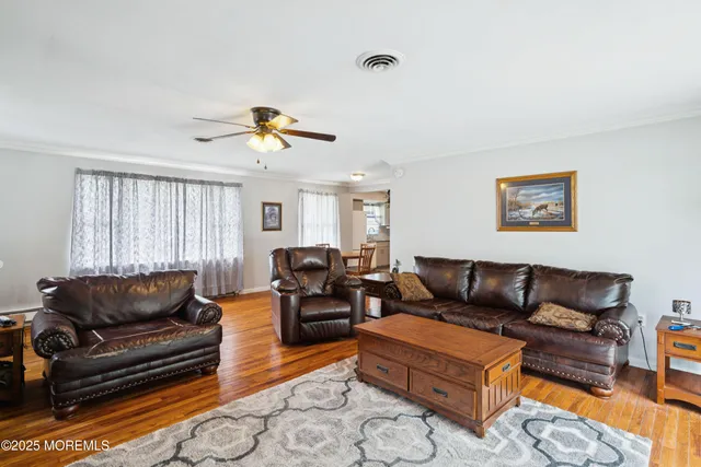 a living room with furniture a couch and a chandelier