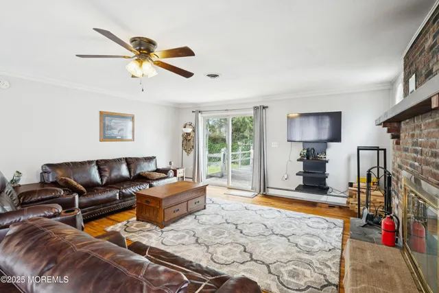 a living room with furniture windows and a flat screen tv