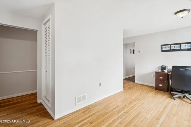 a view of a workspace with wooden floor
