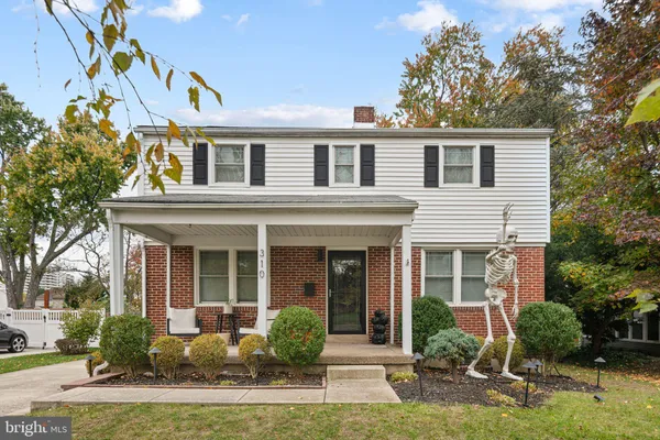 a front view of a house with garden and porch