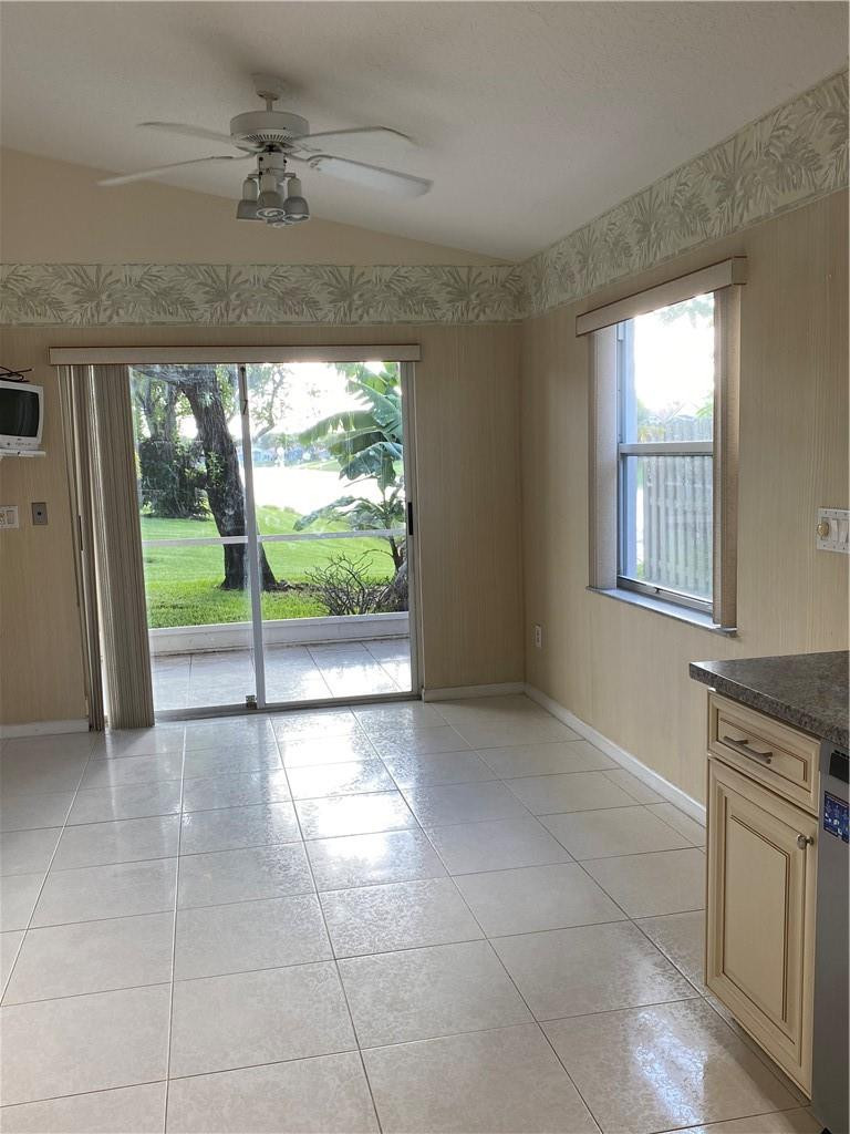 22911 Royal Crown Terrace Boca Raton, FL 33433 - Photo 11 of 18 a view of an empty room with a fireplace and a window