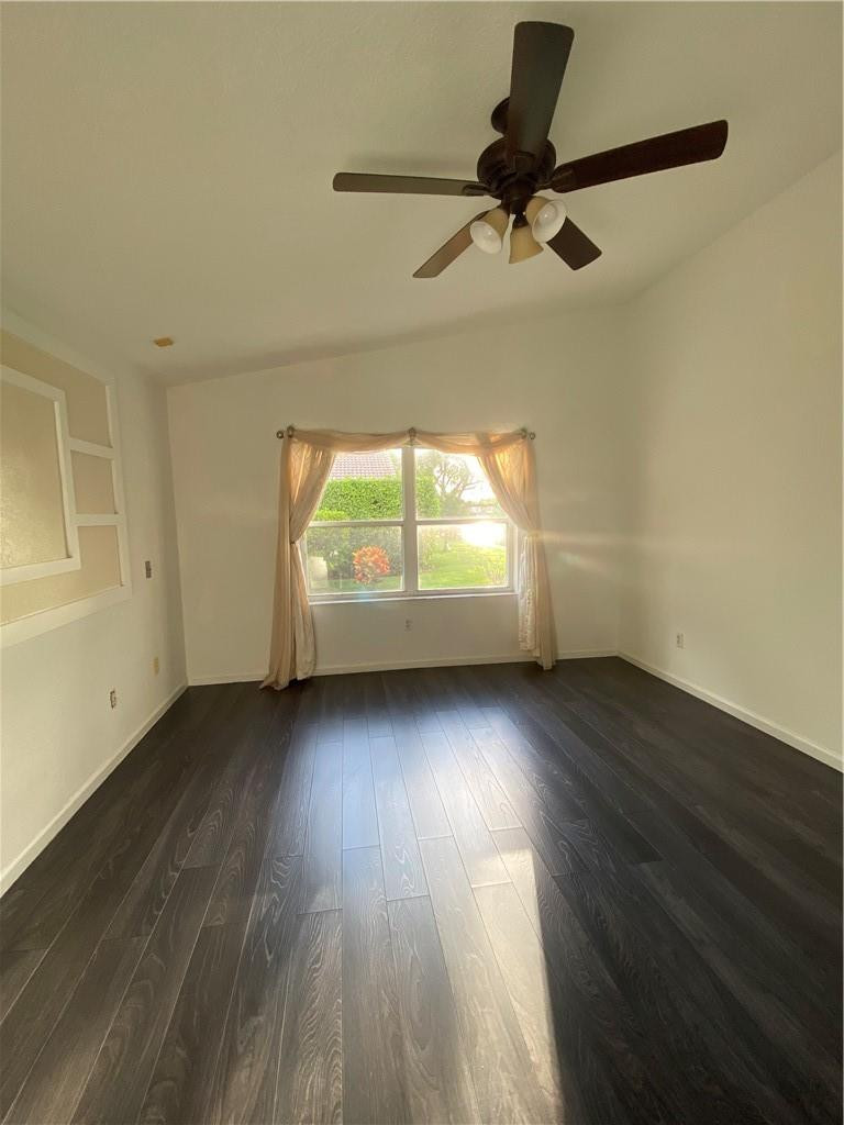 22911 Royal Crown Terrace Boca Raton, FL 33433 - Photo 12 of 18 an empty room with wooden floor and windows