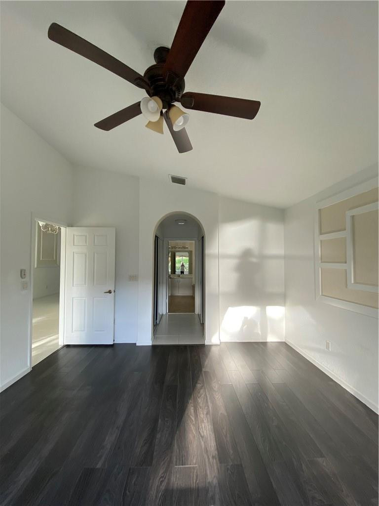 22911 Royal Crown Terrace Boca Raton, FL 33433 - Photo 13 of 18 a view of a room with wooden floor ceiling fan and windows