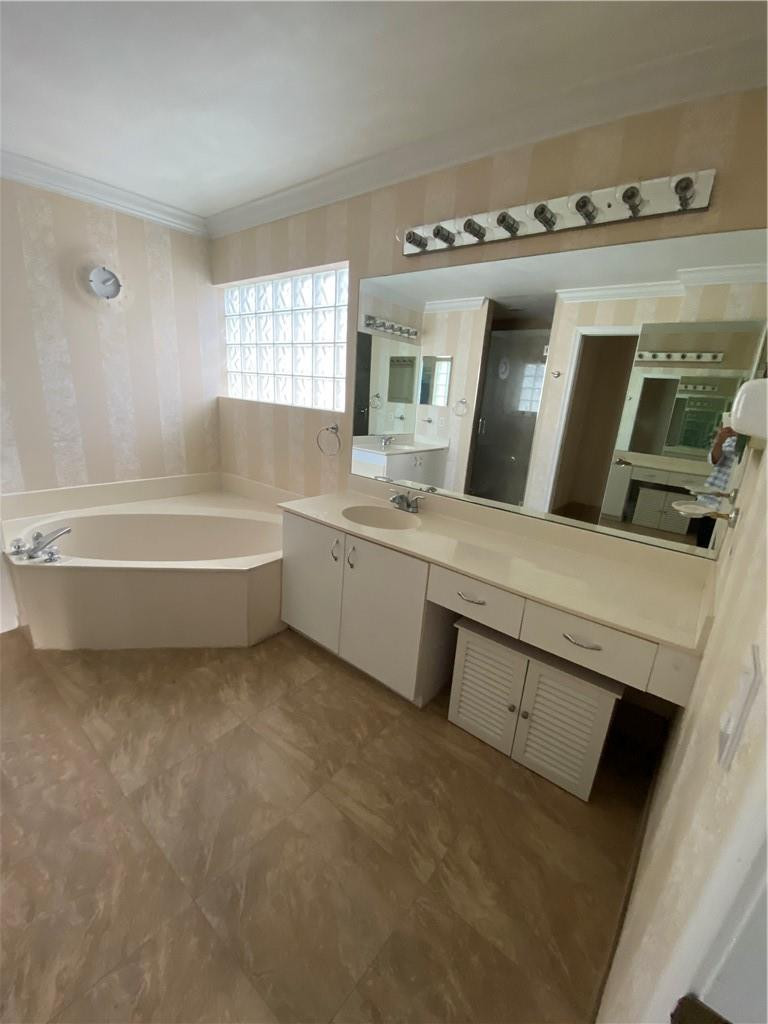 22911 Royal Crown Terrace Boca Raton, FL 33433 - Photo 14 of 18 a bathroom with a tub sink and mirror
