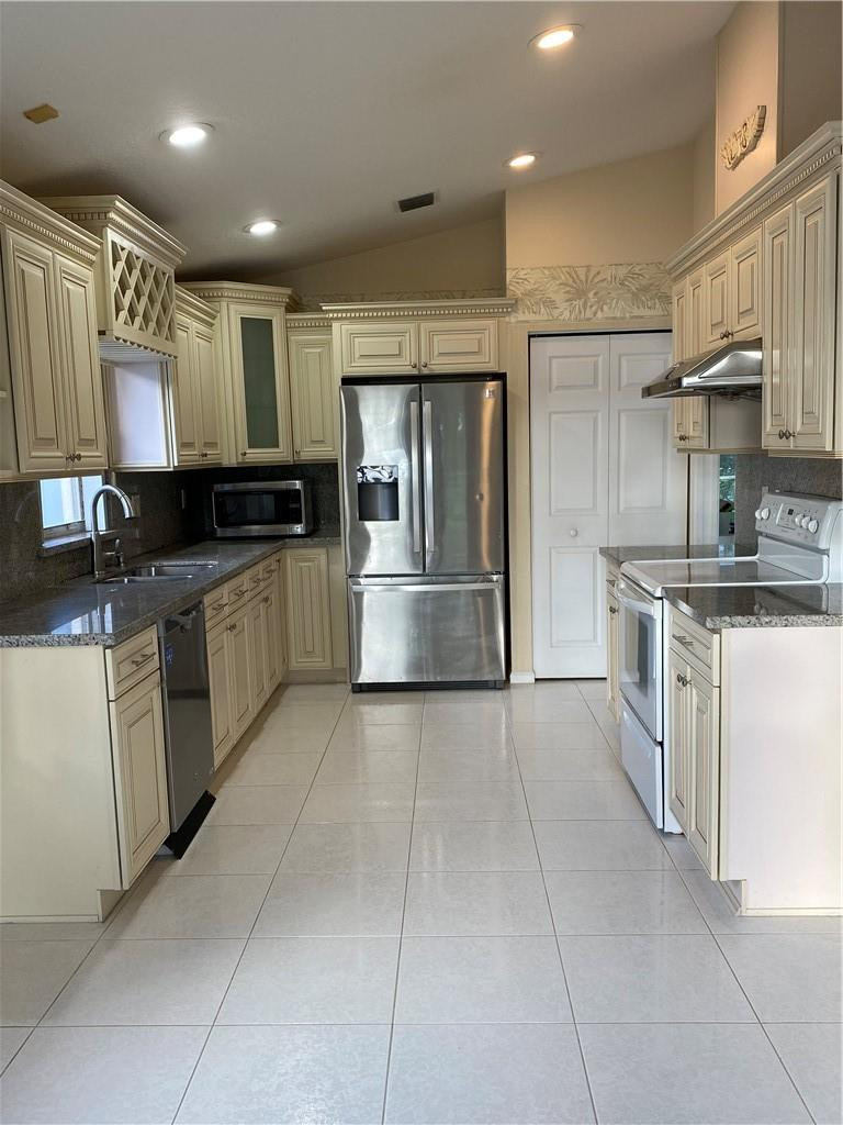 22911 Royal Crown Terrace Boca Raton, FL 33433 - Photo 10 of 18 a kitchen with stainless steel appliances granite countertop a sink and a stove