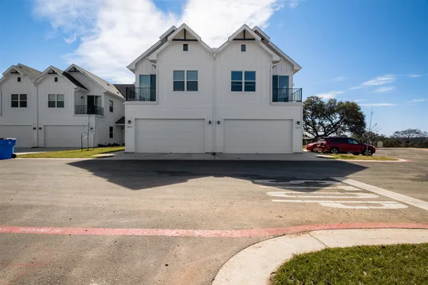 a view of a white house with a yard