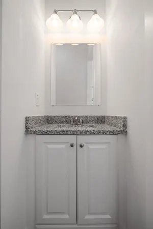a view of an empty room with wooden floor and cabinet
