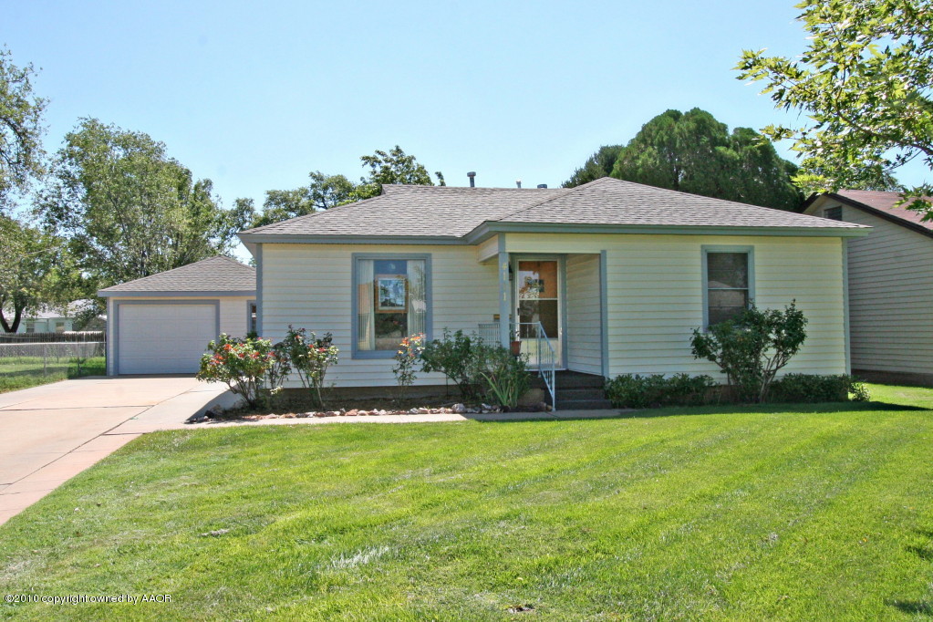 4111 South Travis Street Amarillo, TX 79110 - Photo 1 of 12 a front view of house with yard and green space