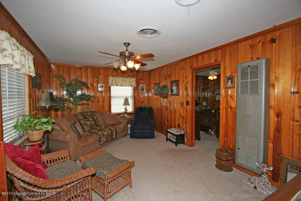 4111 South Travis Street Amarillo, TX 79110 - Photo 9 of 12 a living room with furniture a chandelier and a mirror