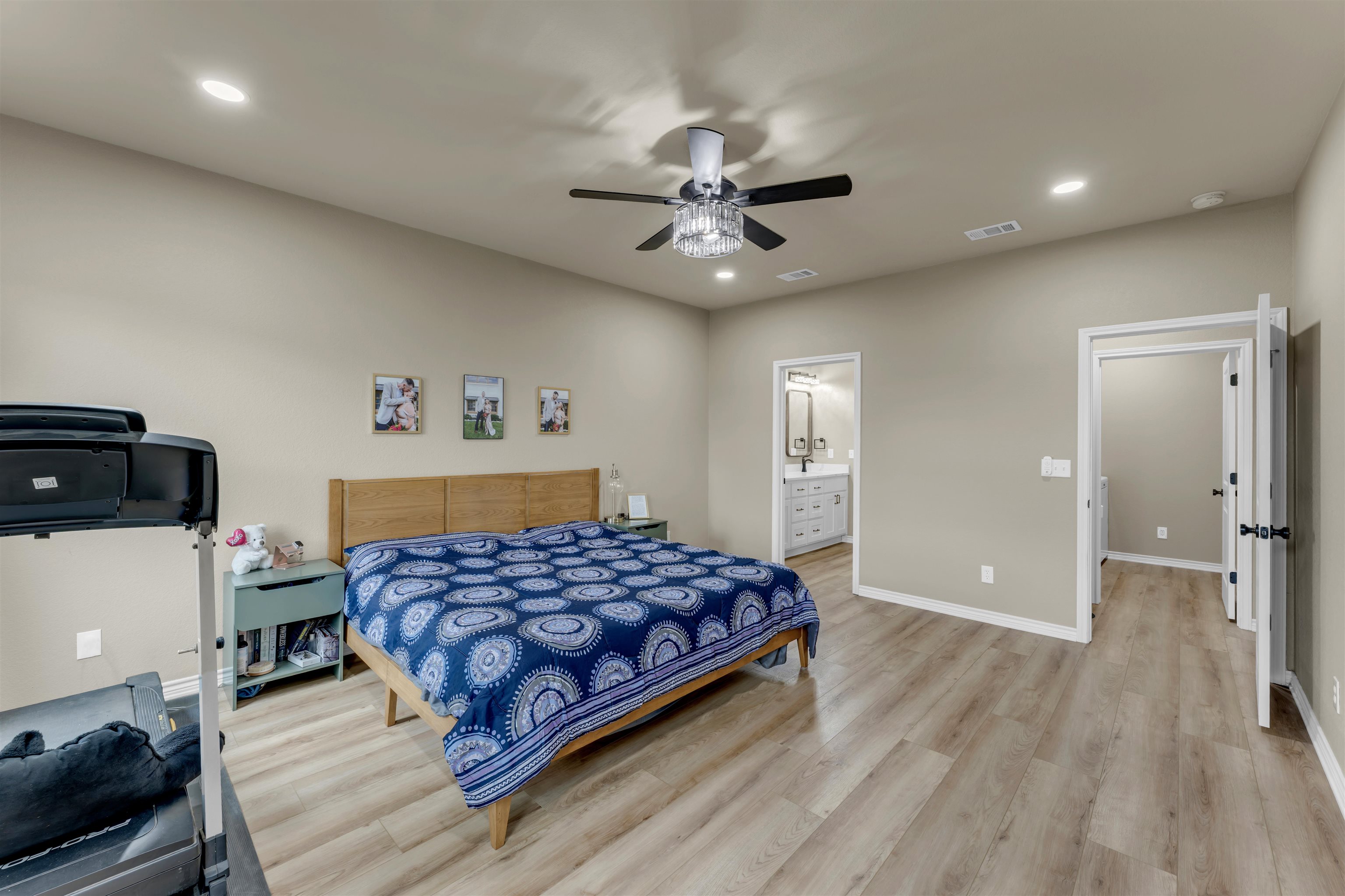 494 Johnson Road Mason, TX 76856 - Photo 18 of 28 a bedroom with a bed and a chandelier
