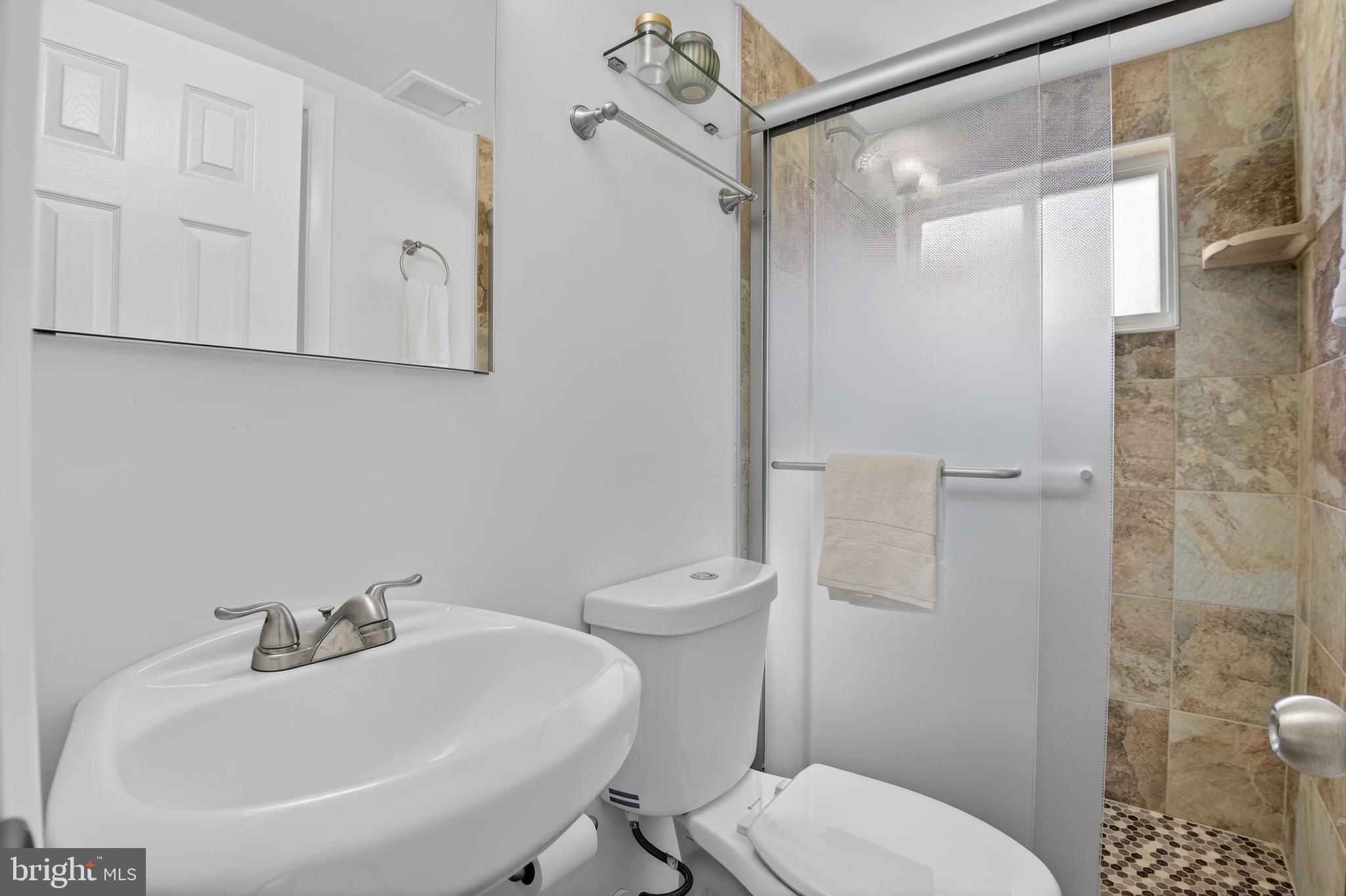 11004 Oakwood Street Silver Spring, MD 20901 - Photo 28 of 35 a bathroom with a sink a toilet and shower