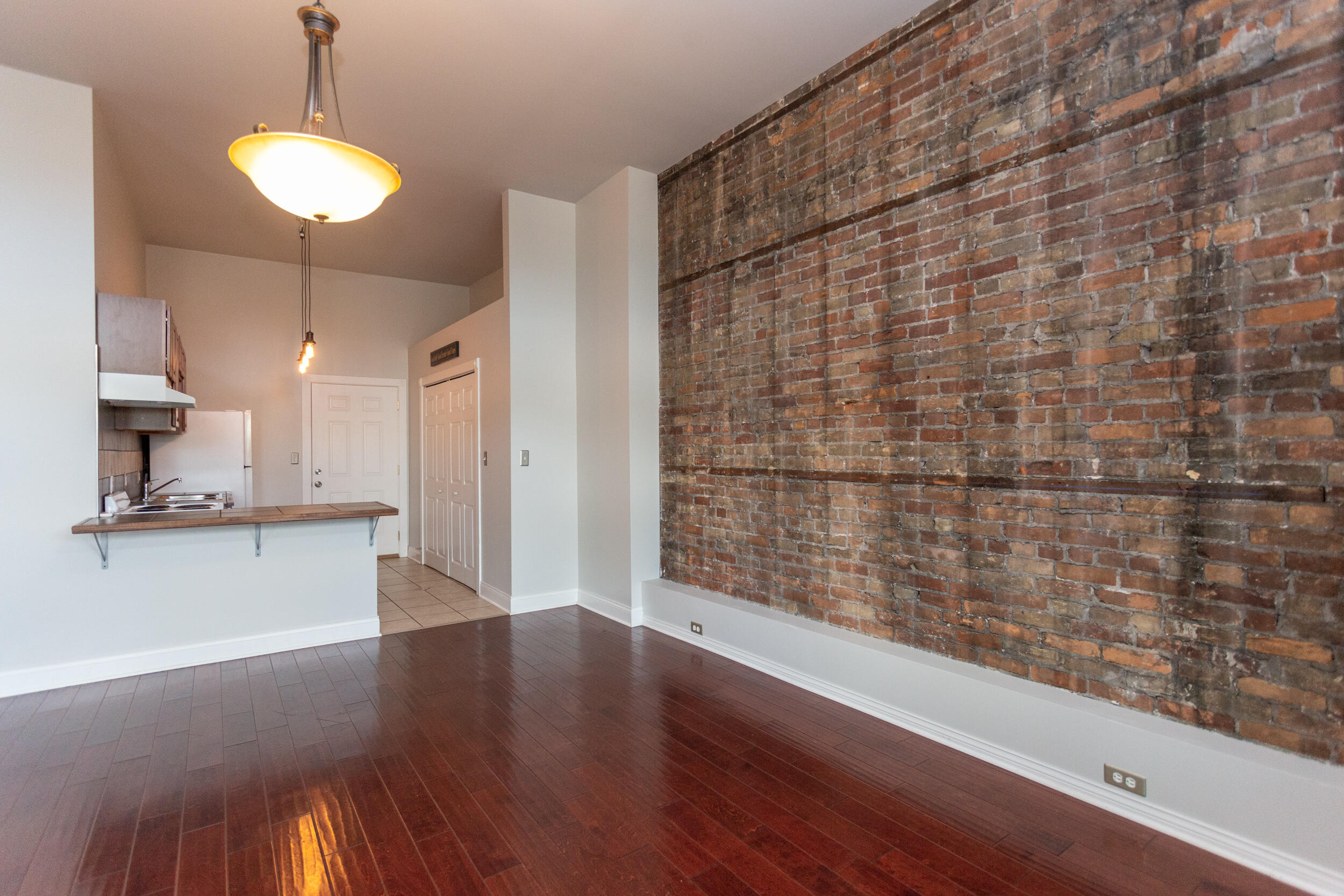 525 Franklin Street, Unit 7 Michigan City, IN 46360 - Photo 12 of 14 a view of a room with wooden floor and a window