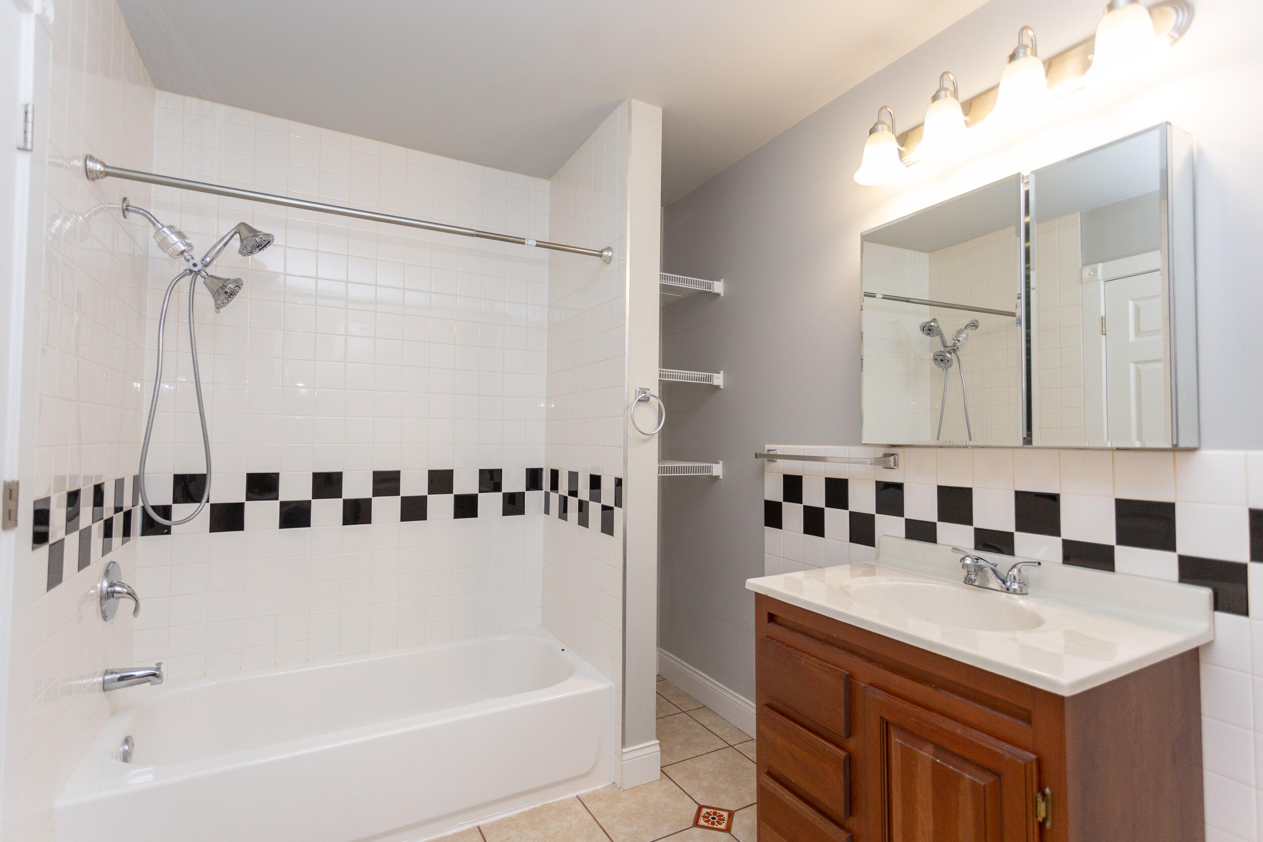 525 Franklin Street, Unit 7 Michigan City, IN 46360 - Photo 14 of 14 a bathroom with a bathtub a sink and a mirror