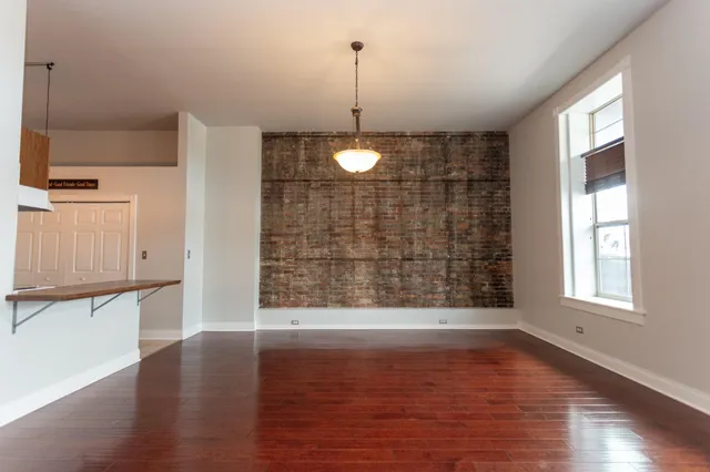 a view of a room with wooden floor and window