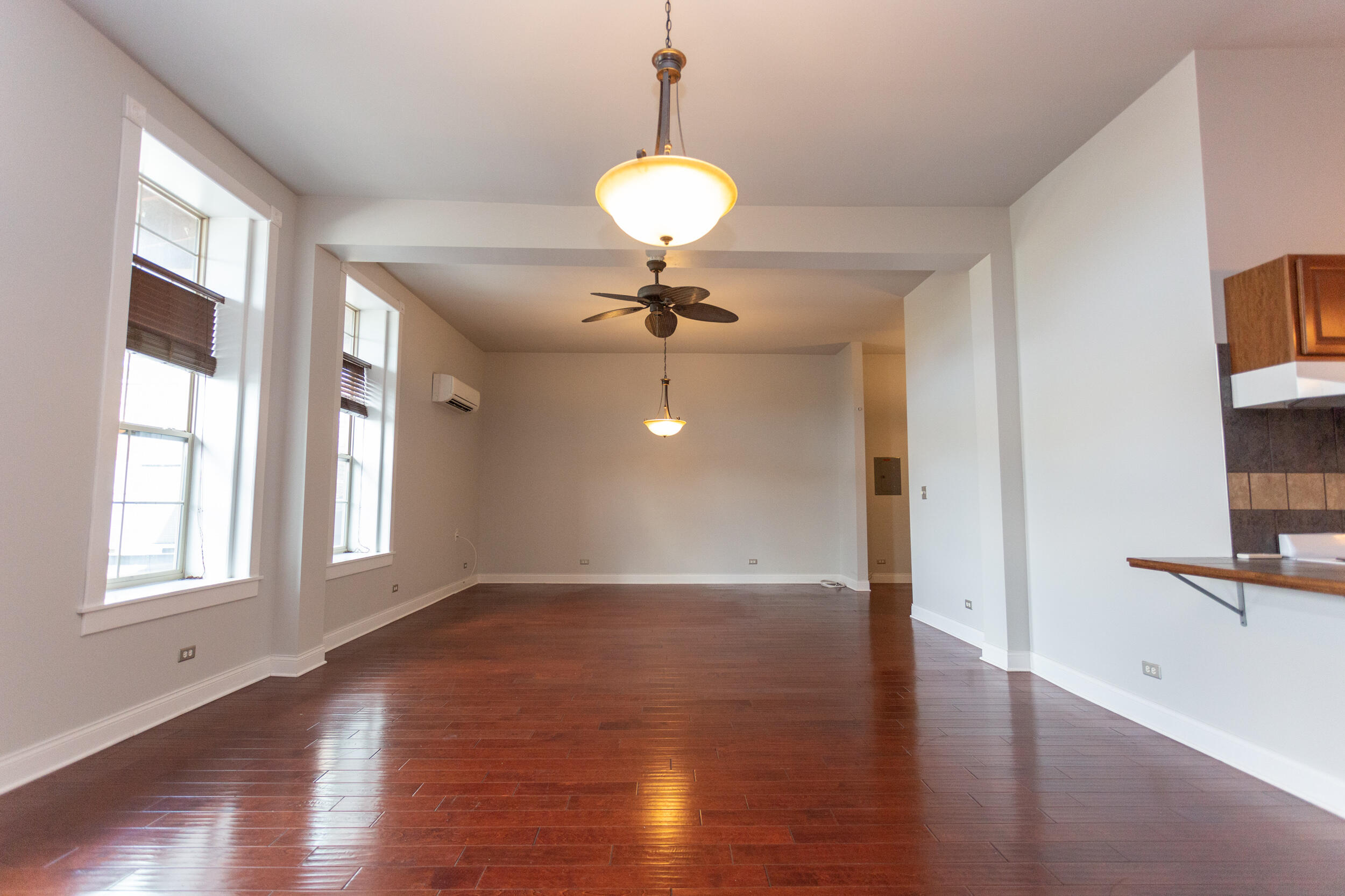 525 Franklin Street, Unit 7 Michigan City, IN 46360 - Photo 5 of 14 a view of an empty room with wooden floor and a window