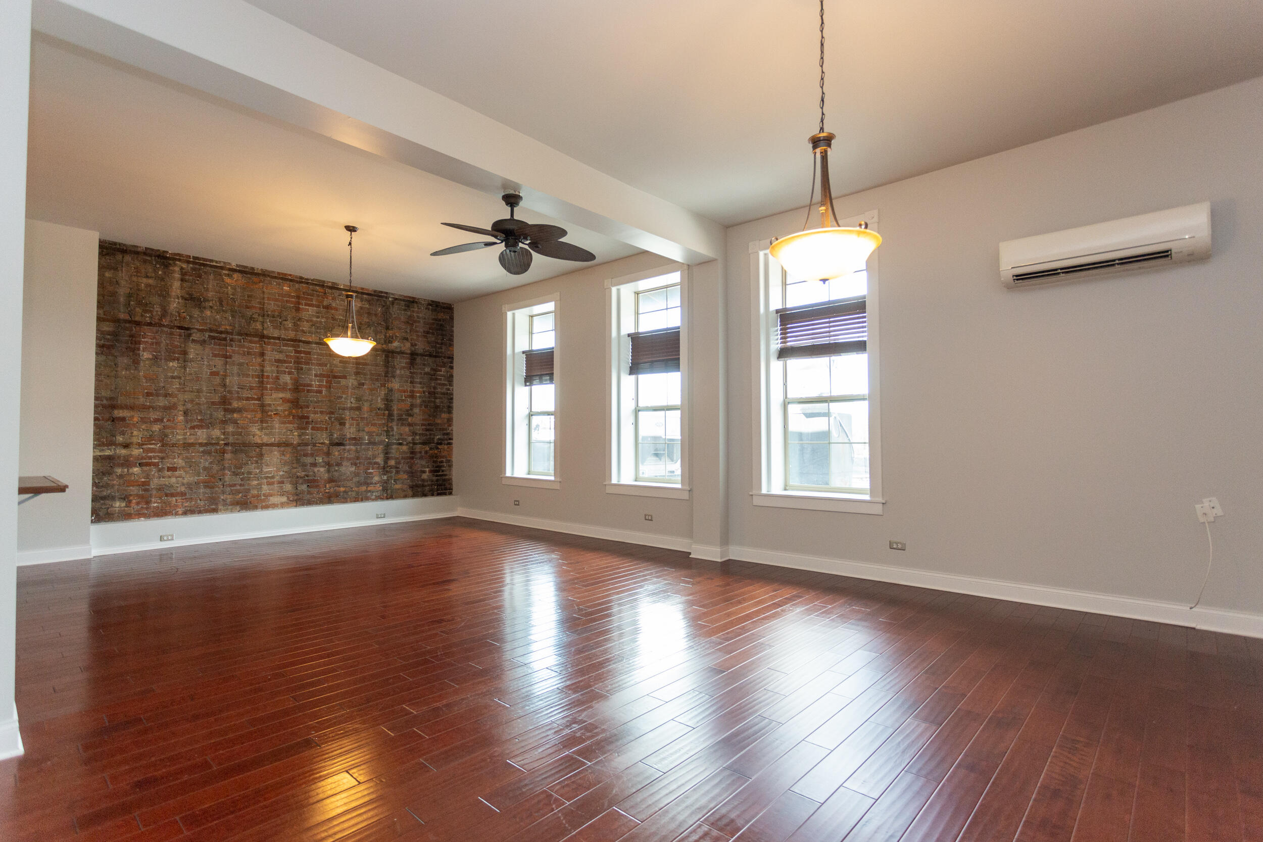 525 Franklin Street, Unit 7 Michigan City, IN 46360 - Photo 6 of 14 a view of wooden floor and a chandelier in a room