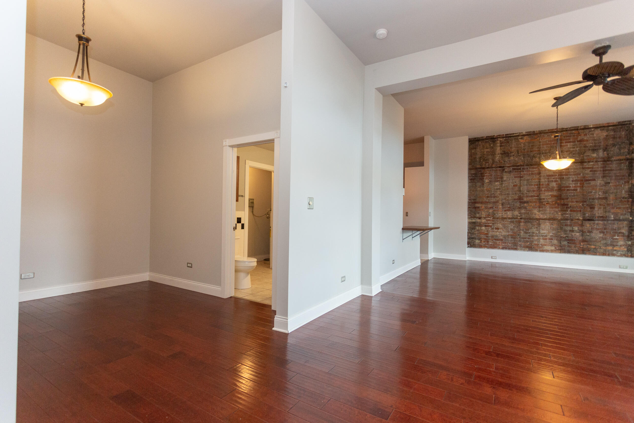 525 Franklin Street, Unit 7 Michigan City, IN 46360 - Photo 9 of 14 a view of a room with wooden floor and fan