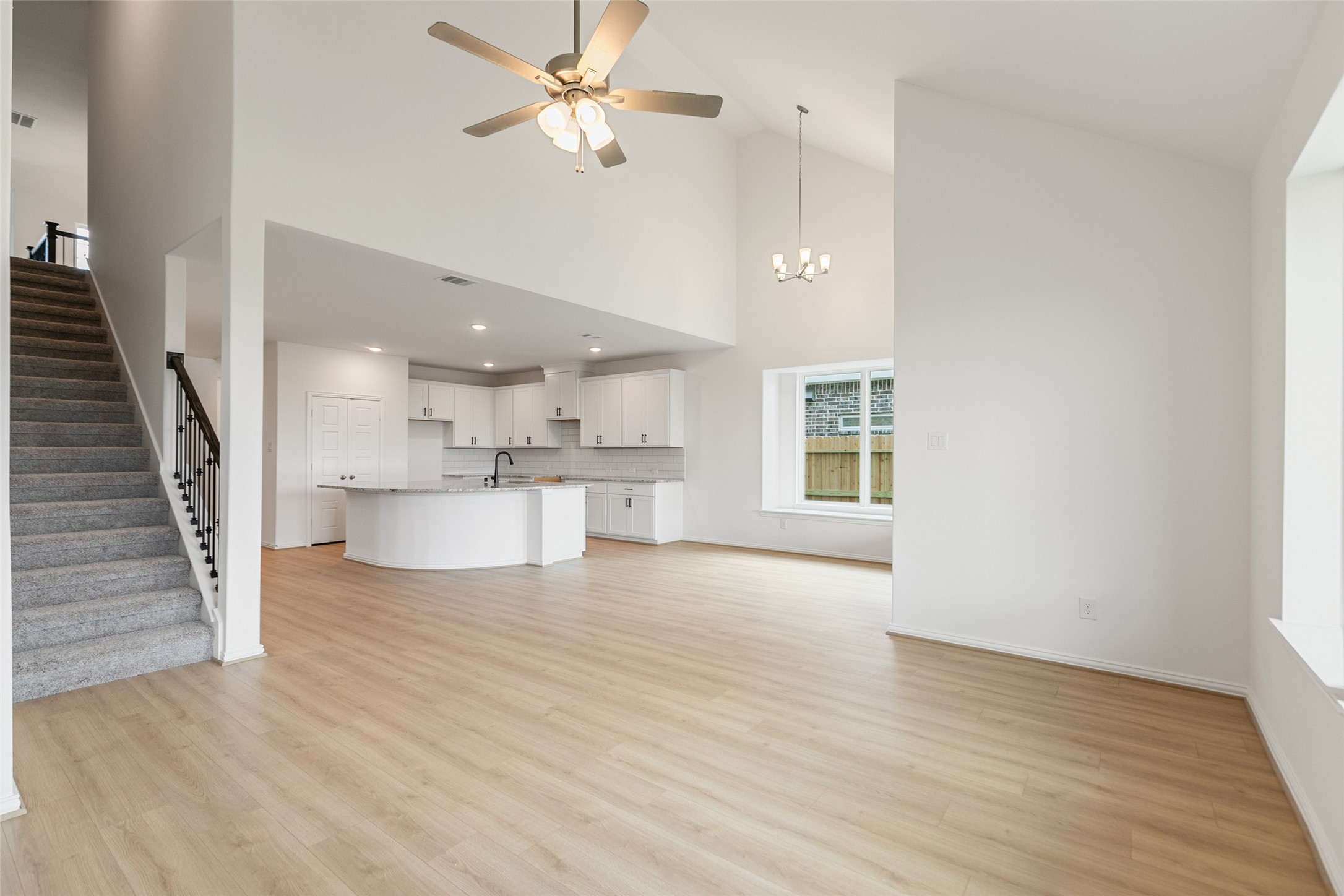 2805 Ruby Laurel Drive Iowa Colony, TX 77583 - Photo 19 of 39 wooden floor in an empty room with a kitchen