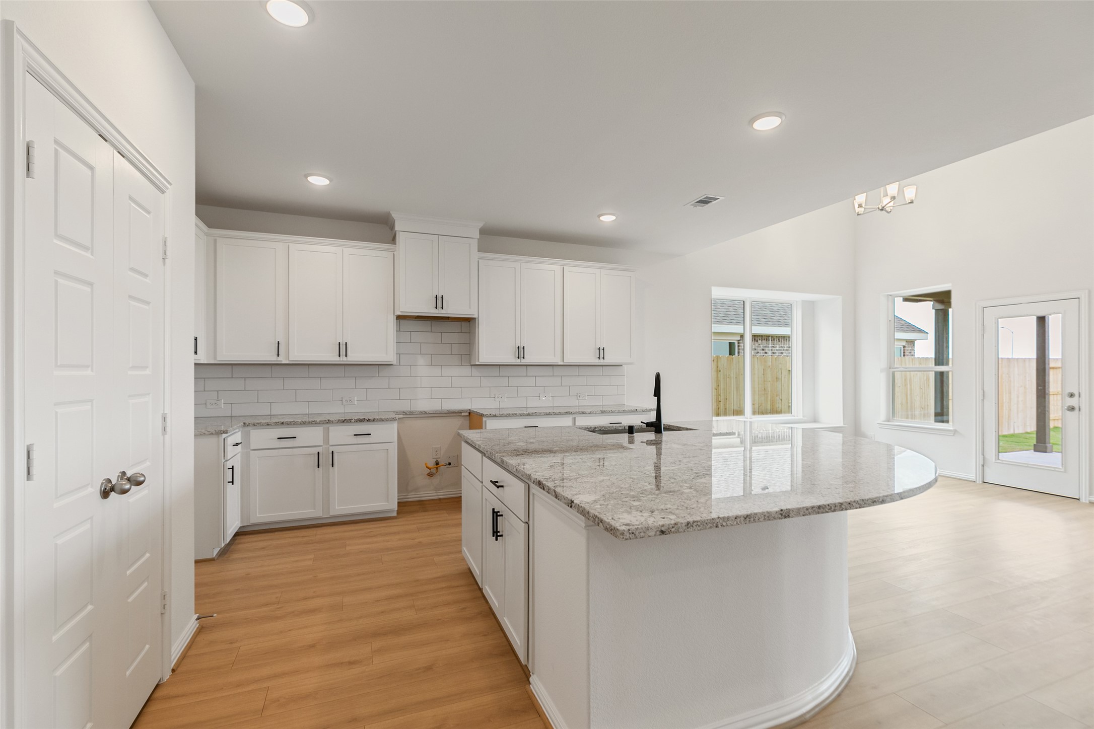 2805 Ruby Laurel Drive Iowa Colony, TX 77583 - Photo 10 of 39 a large kitchen with granite countertop a sink and dishwasher with a white countertops