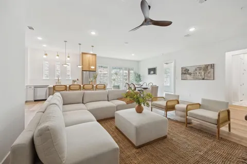 a living room with furniture and a wooden floor