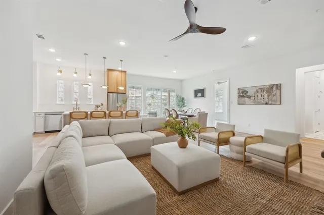 a living room with furniture and a wooden floor