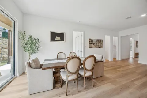 a dining room with furniture and wooden floor