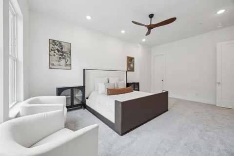 a room with a bed and a ceiling fan