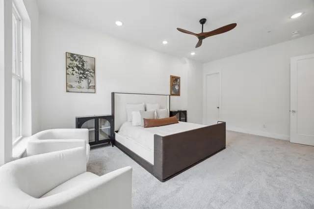 a room with a bed and a ceiling fan