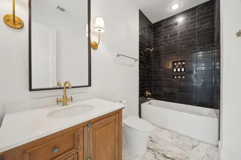 a bathroom with a sink a toilet a shower and bathtub