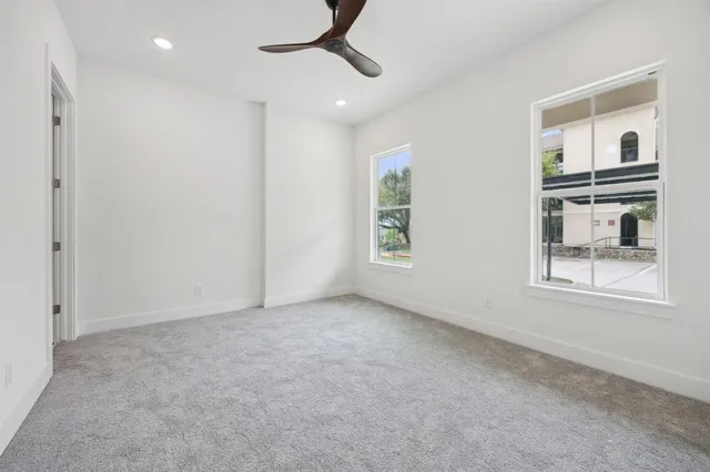 an empty room with windows and closet