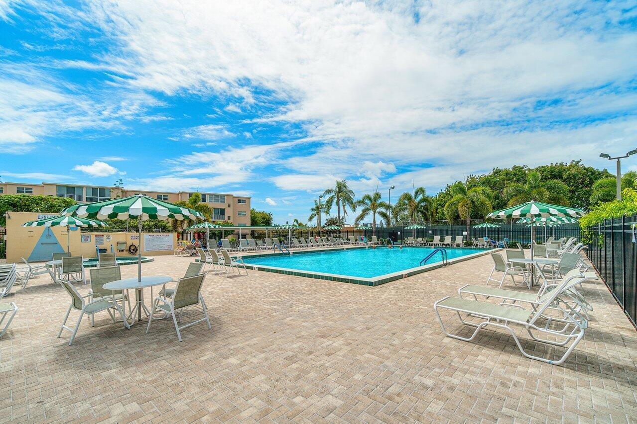 2615 Northeast 1st Court, Unit 301 Boynton Beach, FL 33435 - Photo 1 of 40 an outdoor space with swimming pool and furniture