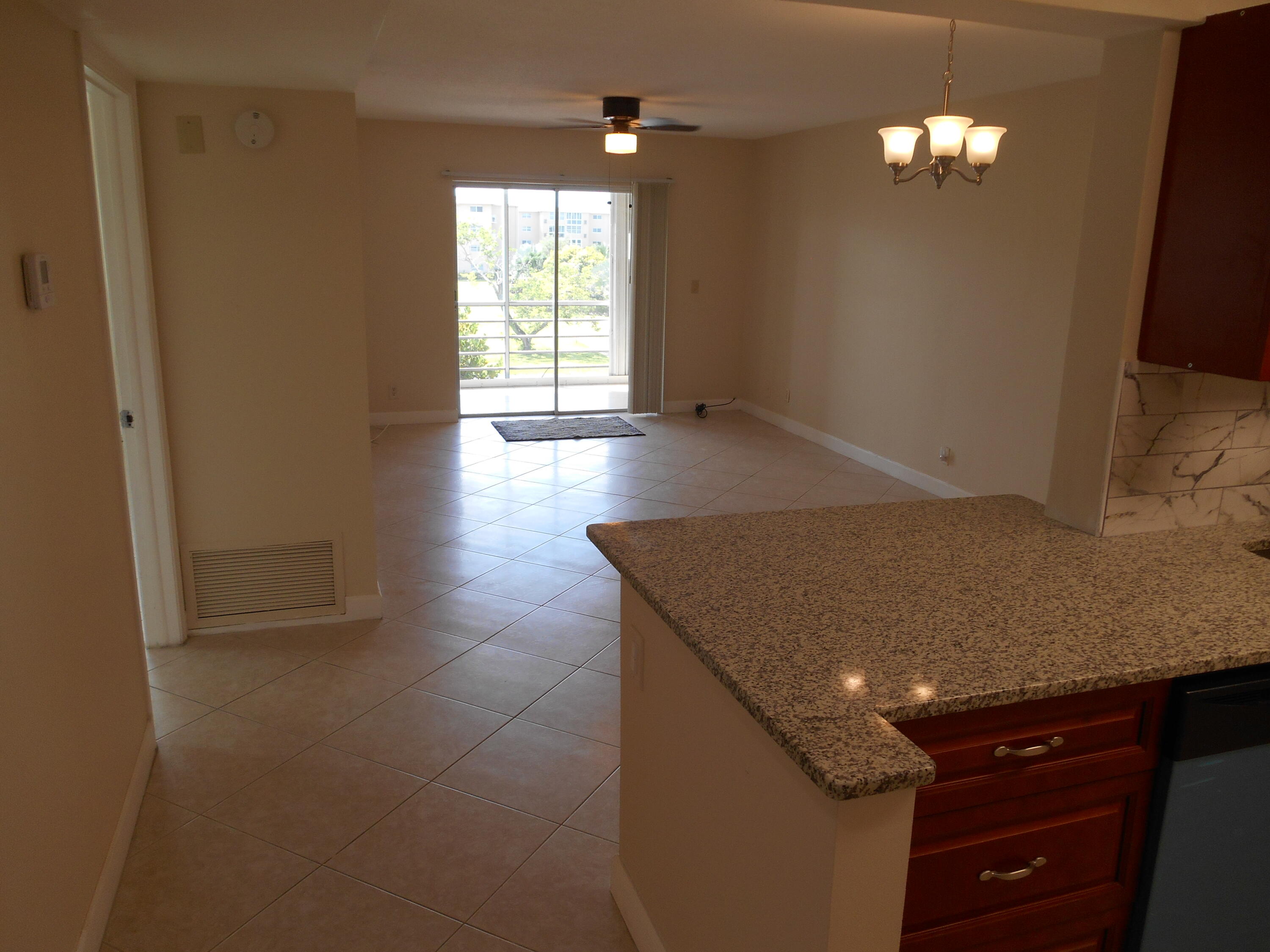 2615 Northeast 1st Court, Unit 301 Boynton Beach, FL 33435 - Photo 11 of 40 wooden floor in an empty room