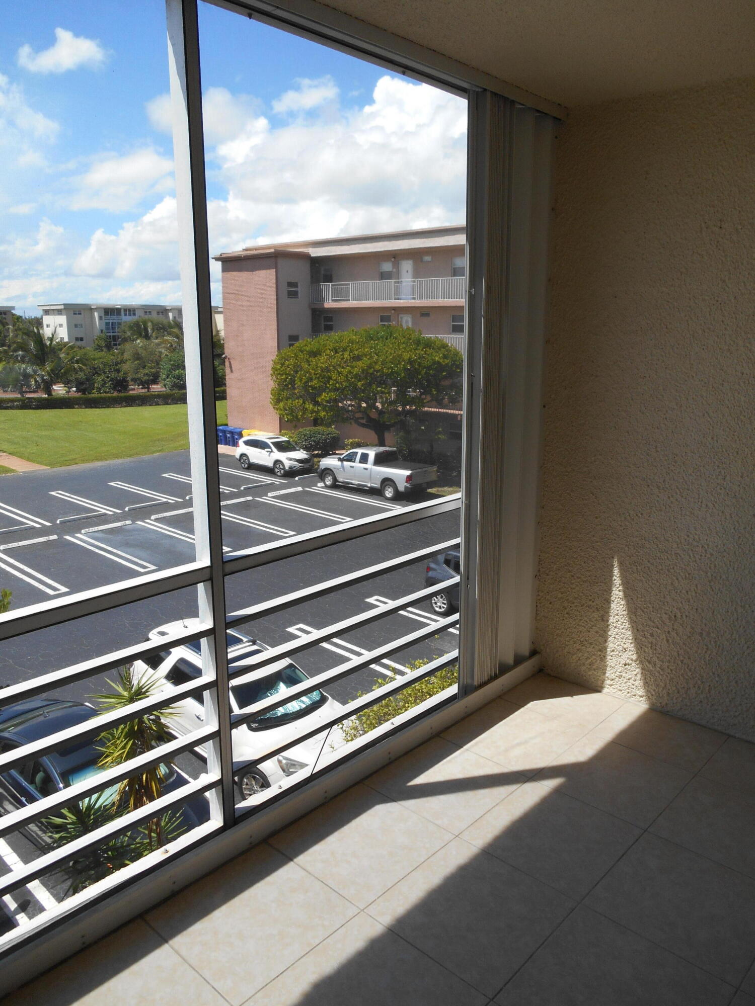 2615 Northeast 1st Court, Unit 301 Boynton Beach, FL 33435 - Photo 14 of 40 a view of a room with wooden floor and iron stairs