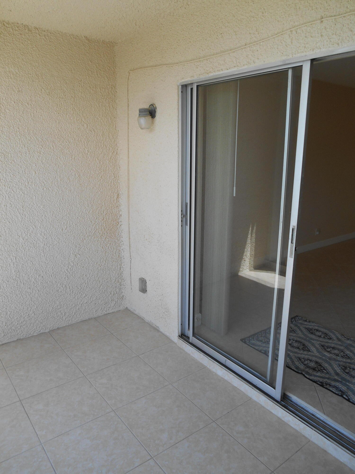 2615 Northeast 1st Court, Unit 301 Boynton Beach, FL 33435 - Photo 16 of 40 an empty room with sliding door