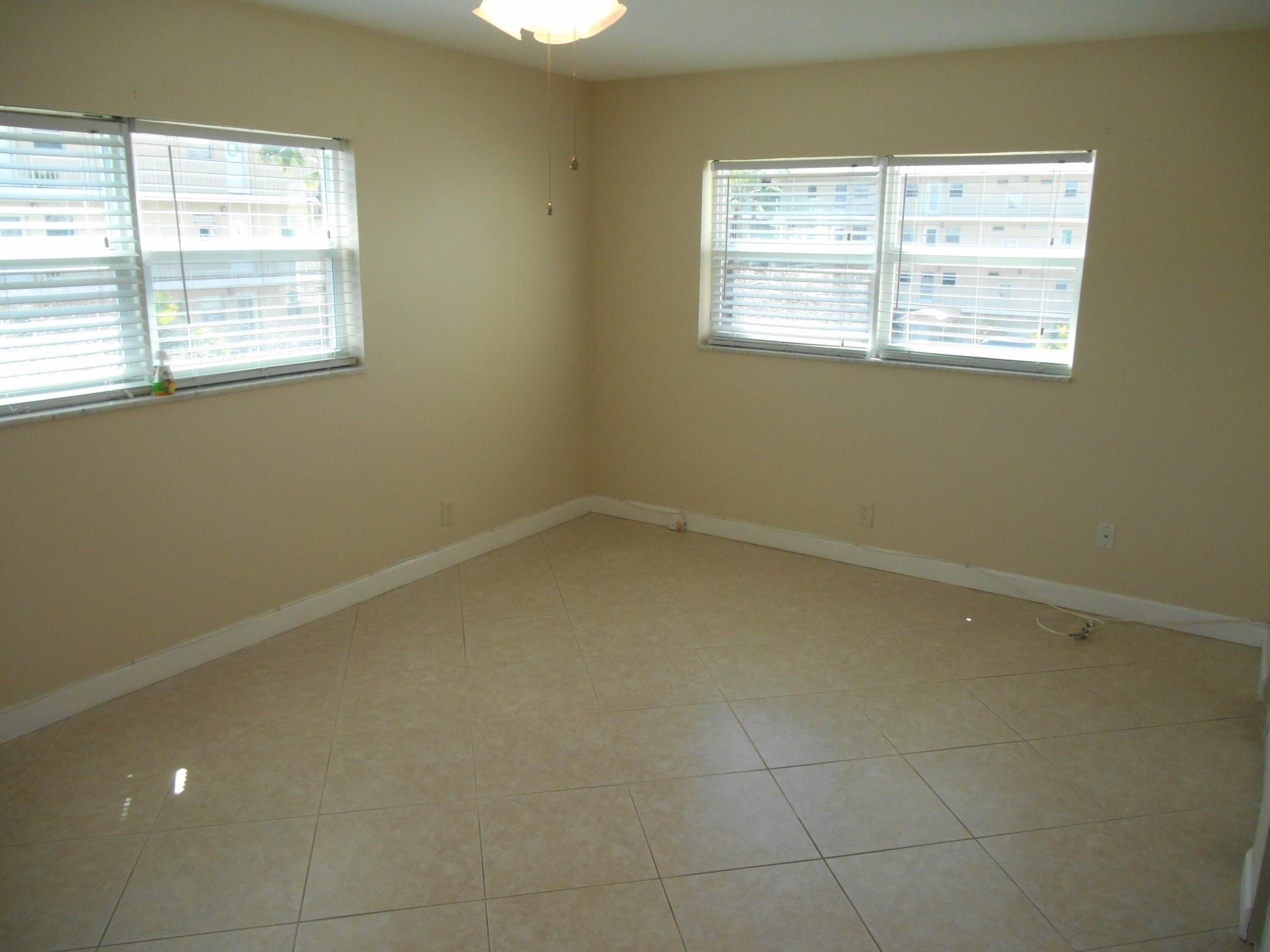 2615 Northeast 1st Court, Unit 301 Boynton Beach, FL 33435 - Photo 20 of 40 an empty room with a window