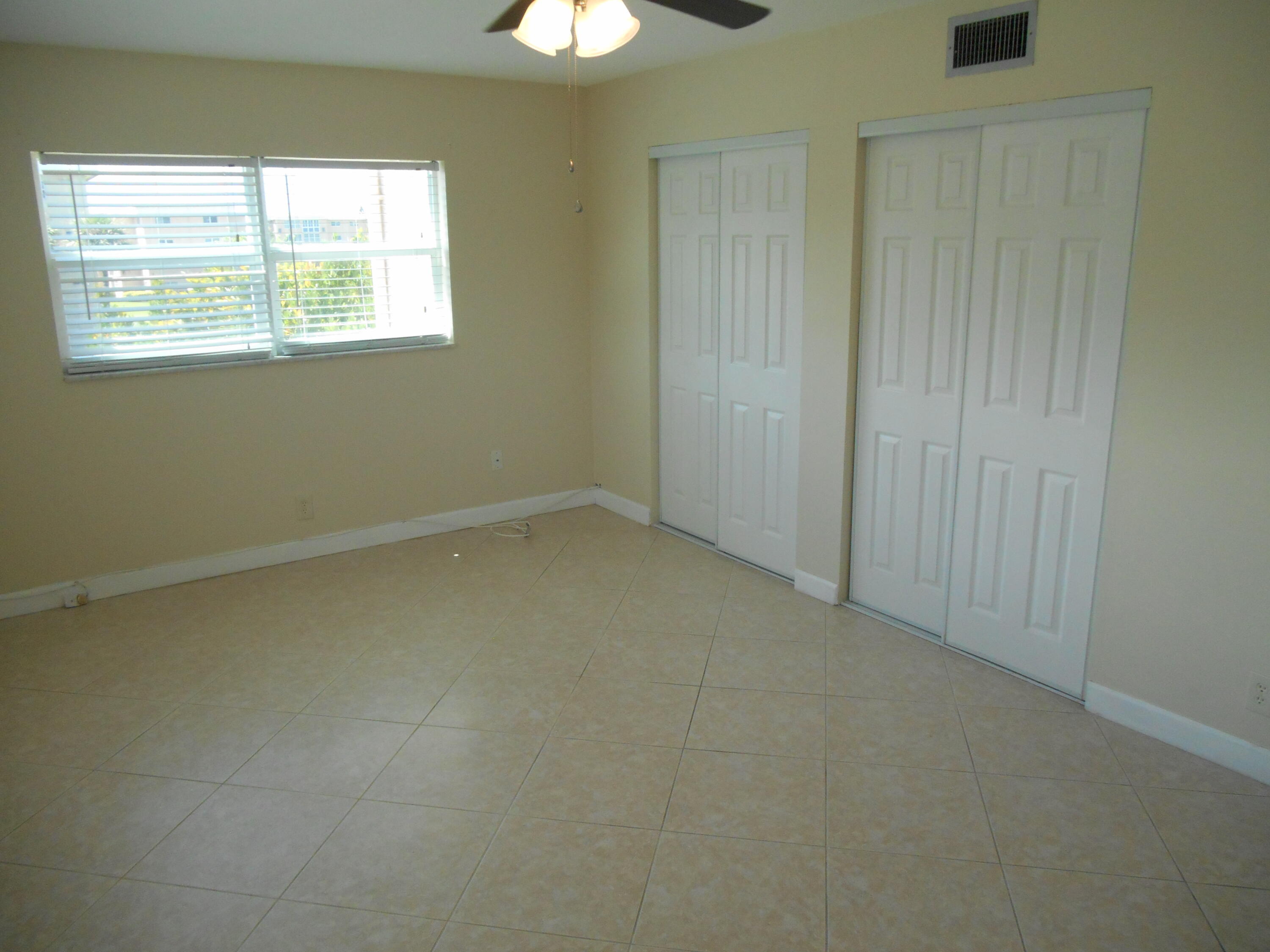 2615 Northeast 1st Court, Unit 301 Boynton Beach, FL 33435 - Photo 21 of 40 an empty room with a window