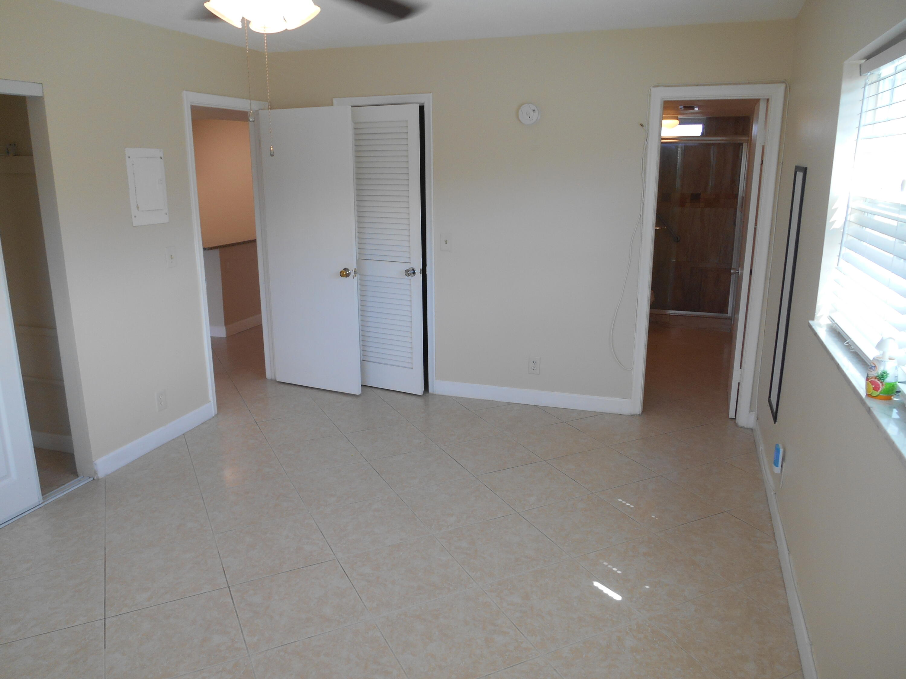 2615 Northeast 1st Court, Unit 301 Boynton Beach, FL 33435 - Photo 22 of 40 an empty room with windows and closet
