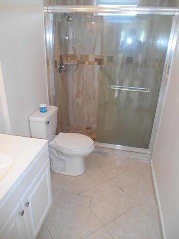 a bathroom with a shower a toilet and a shower