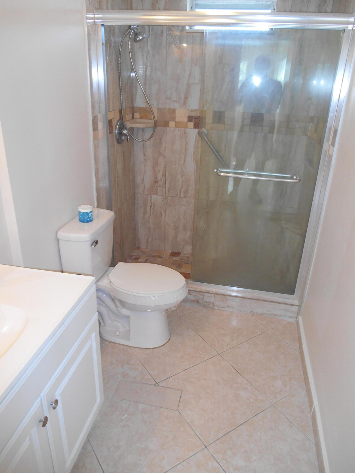 2615 Northeast 1st Court, Unit 301 Boynton Beach, FL 33435 - Photo 25 of 40 a bathroom with a toilet and a shower
